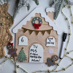 Decorative gingerbread house-shaped board with Christmas elements on a white background