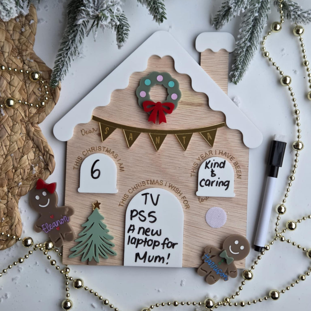 Decorative gingerbread house-shaped board with Christmas elements on a white background