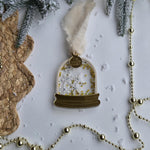 Decorative gold ornament with snowflake design on a white background with decorative elements.